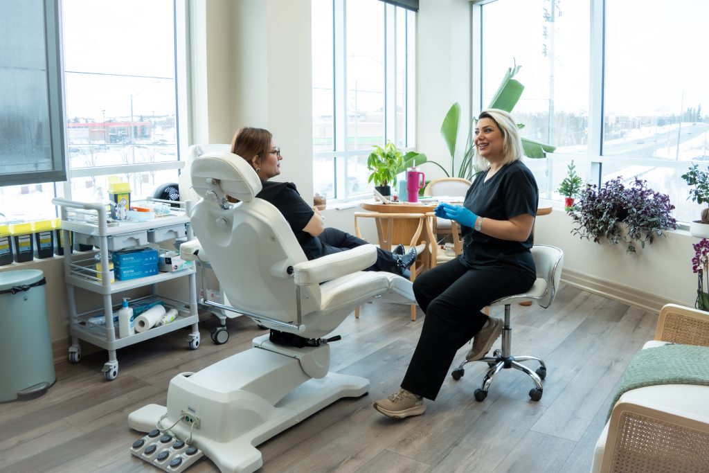 Skincare professional preparing a client for advanced skin injection.