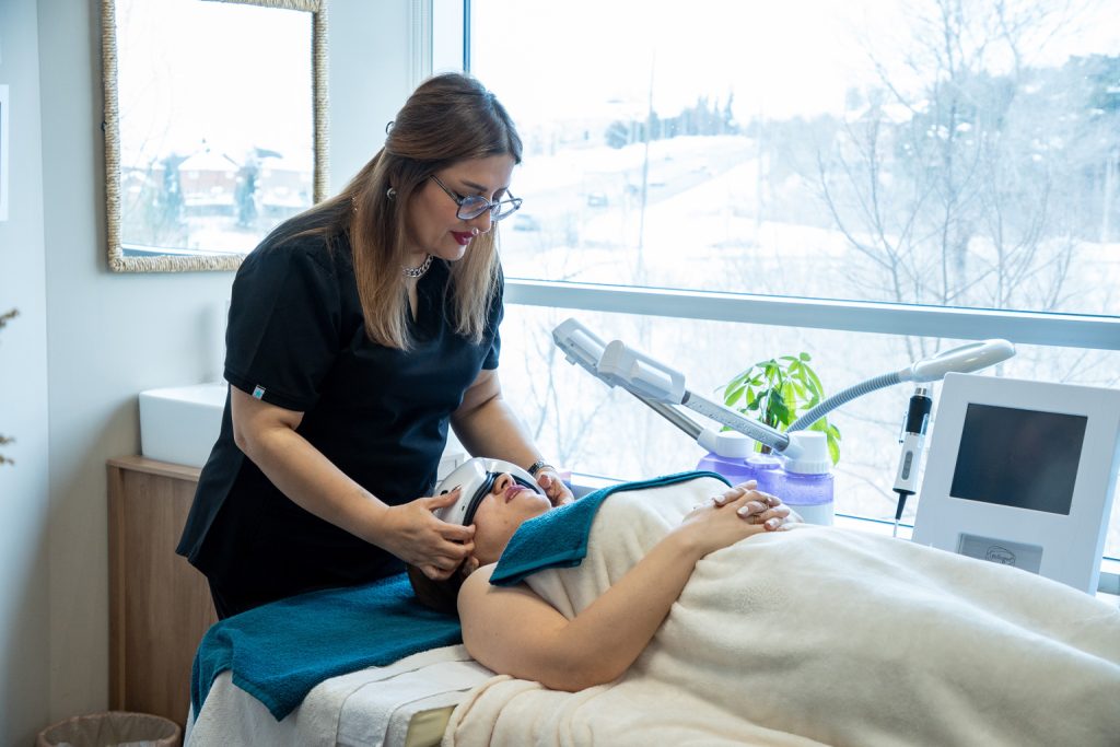 Facial treatment professional operating on a patient.