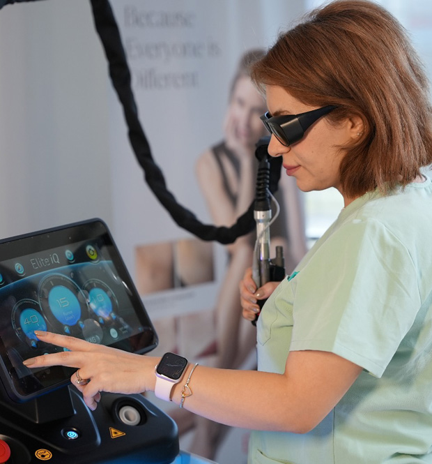 Aesthetic skincare professional in Richmond Hill operating an EliteQ Cynosure machine.